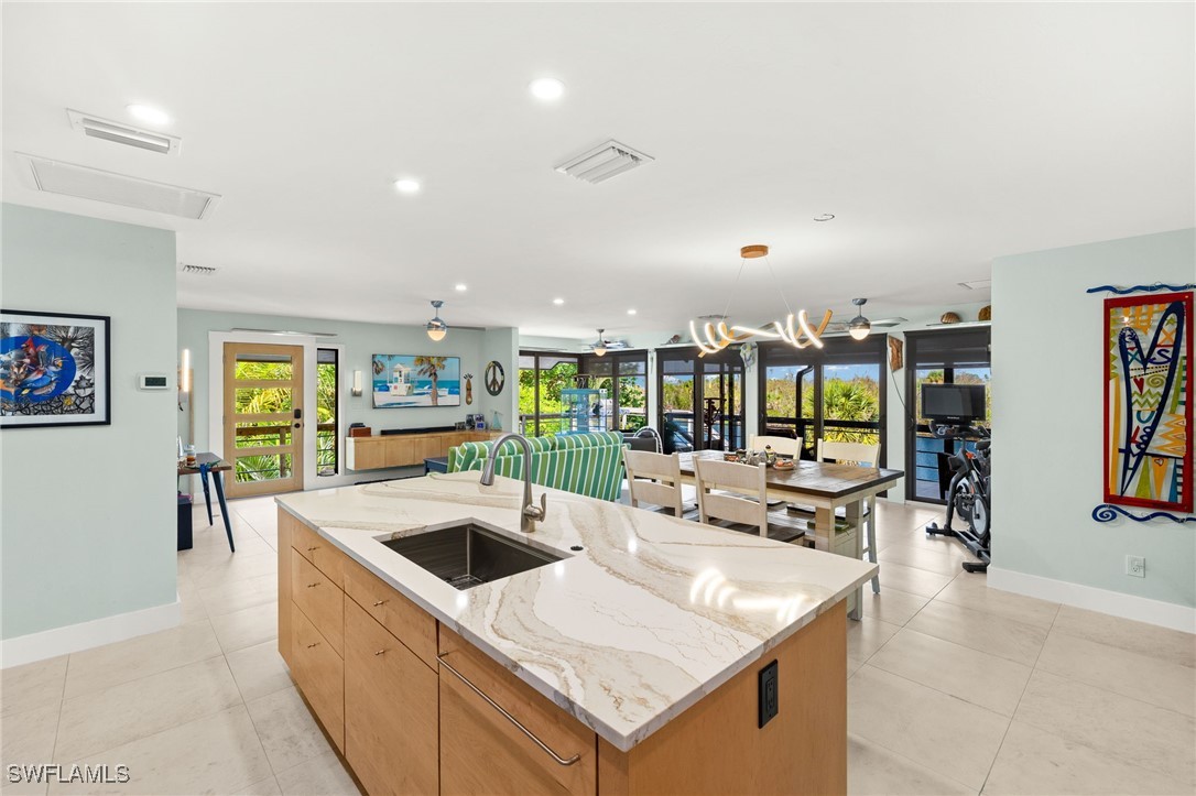 771 Rabbit Road Sanibel, FL 33957 - Photo 8 of 35 a large kitchen with a large window and table
