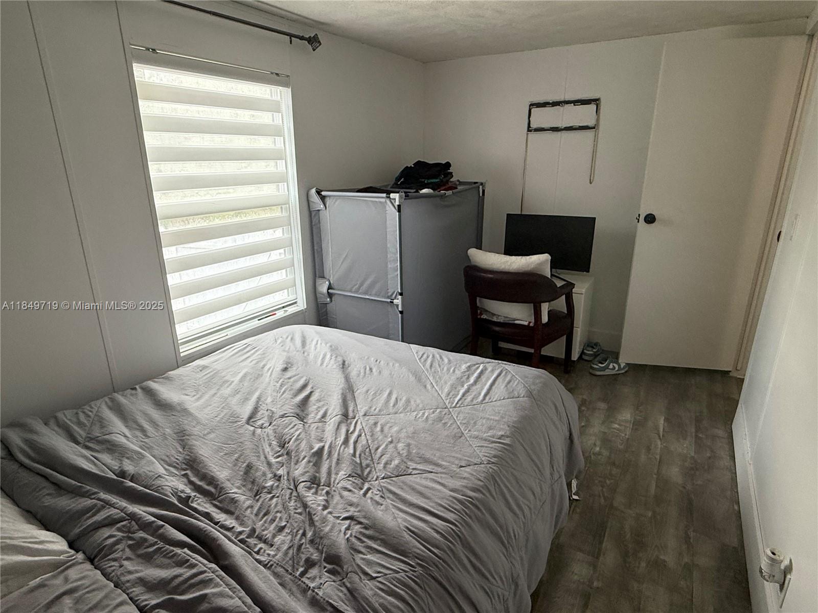 830 South Kennel Street Clewiston, FL 33440 - Photo 16 of 30 a bedroom with a bed and a window