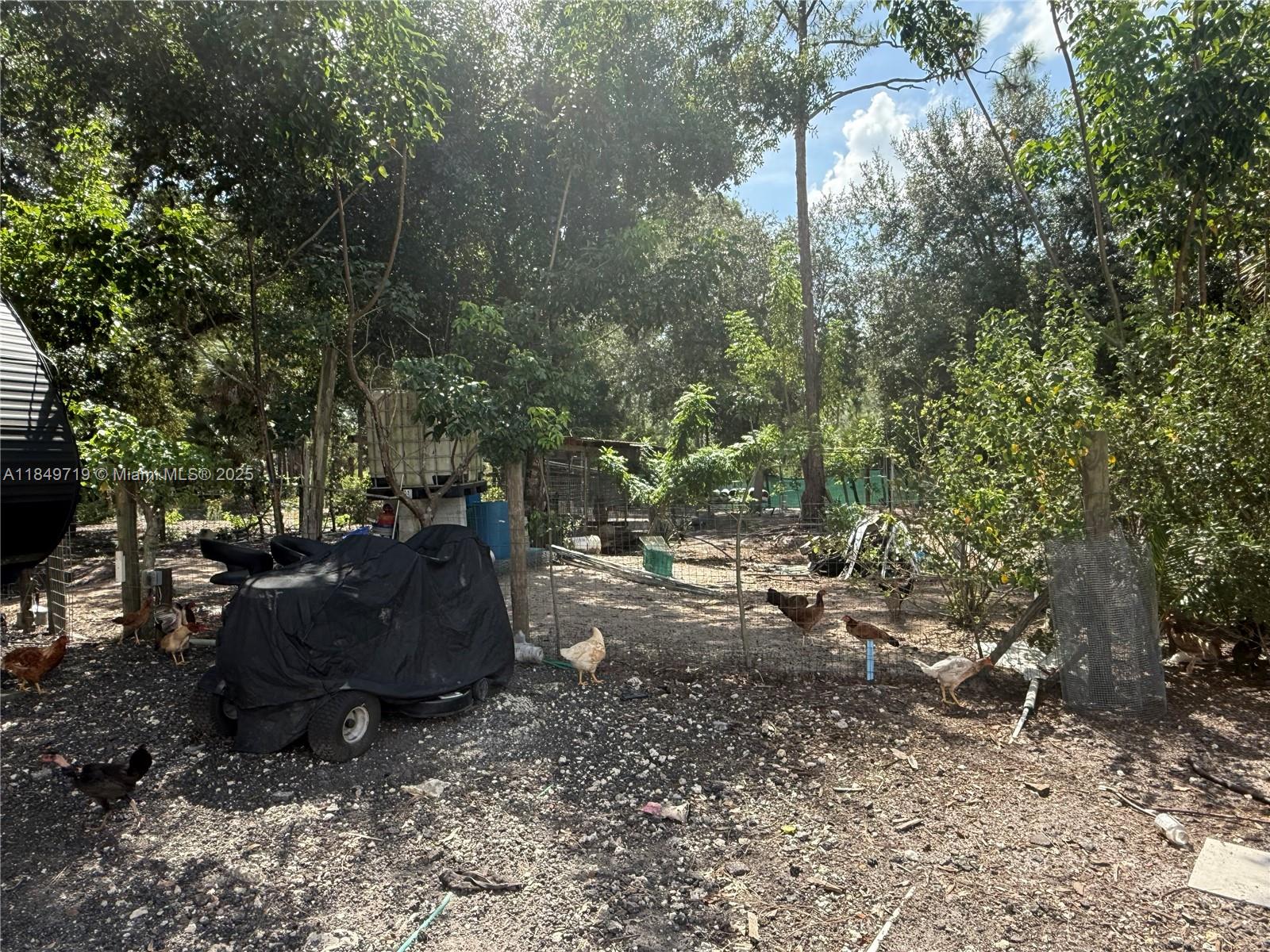 830 South Kennel Street Clewiston, FL 33440 - Photo 27 of 30 a backyard of a house with outdoor seating