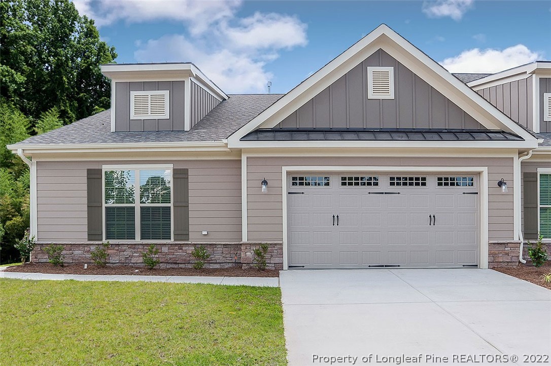 25 Winged Foot Road Pinehurst, NC 28374 - Photo 1 of 41 a front view of a house with a garden and garage