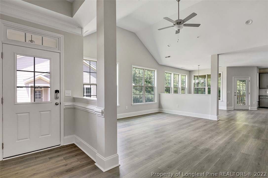 25 Winged Foot Road Pinehurst, NC 28374 - Photo 5 of 41 a view of an empty room with a window and wooden floor