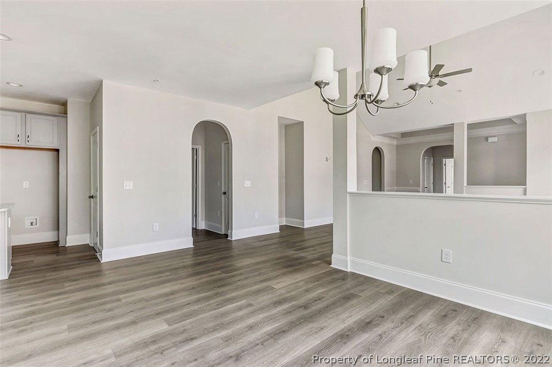 25 Winged Foot Road Pinehurst, NC 28374 - Photo 8 of 41 a view of a livingroom with wooden floor and staircase