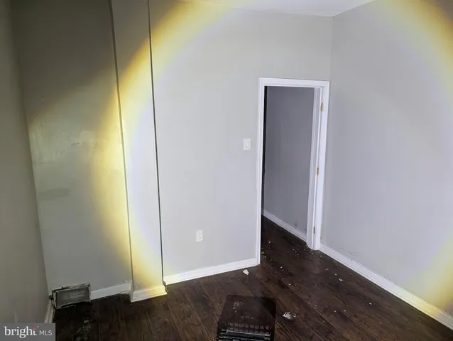 a view of an empty room and wooden floor