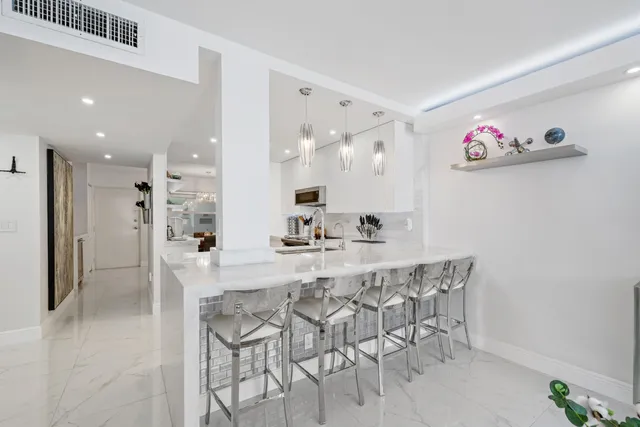 a large kitchen with a table and chairs