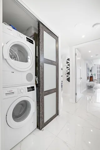 a bathroom with a sink a toilet a window and shower