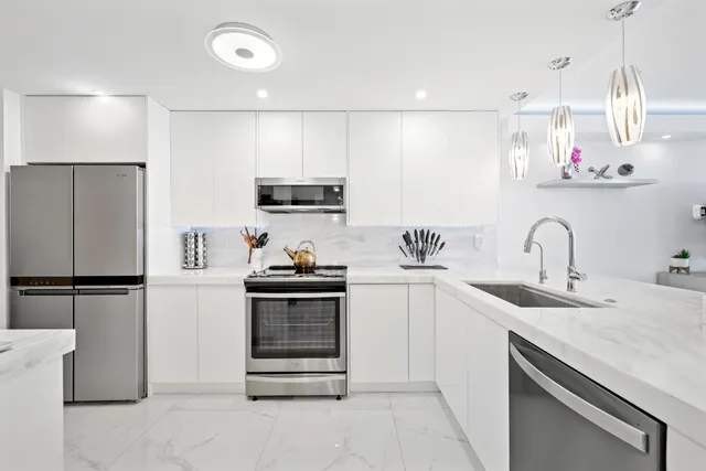 a kitchen with a sink appliances and cabinets