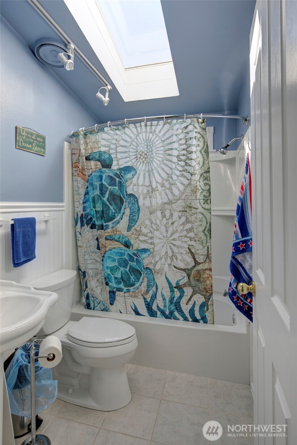 1362 Oceano Drive Grayland, WA 98547 - Photo 21 of 35 a bathroom with a toilet and shower curtain