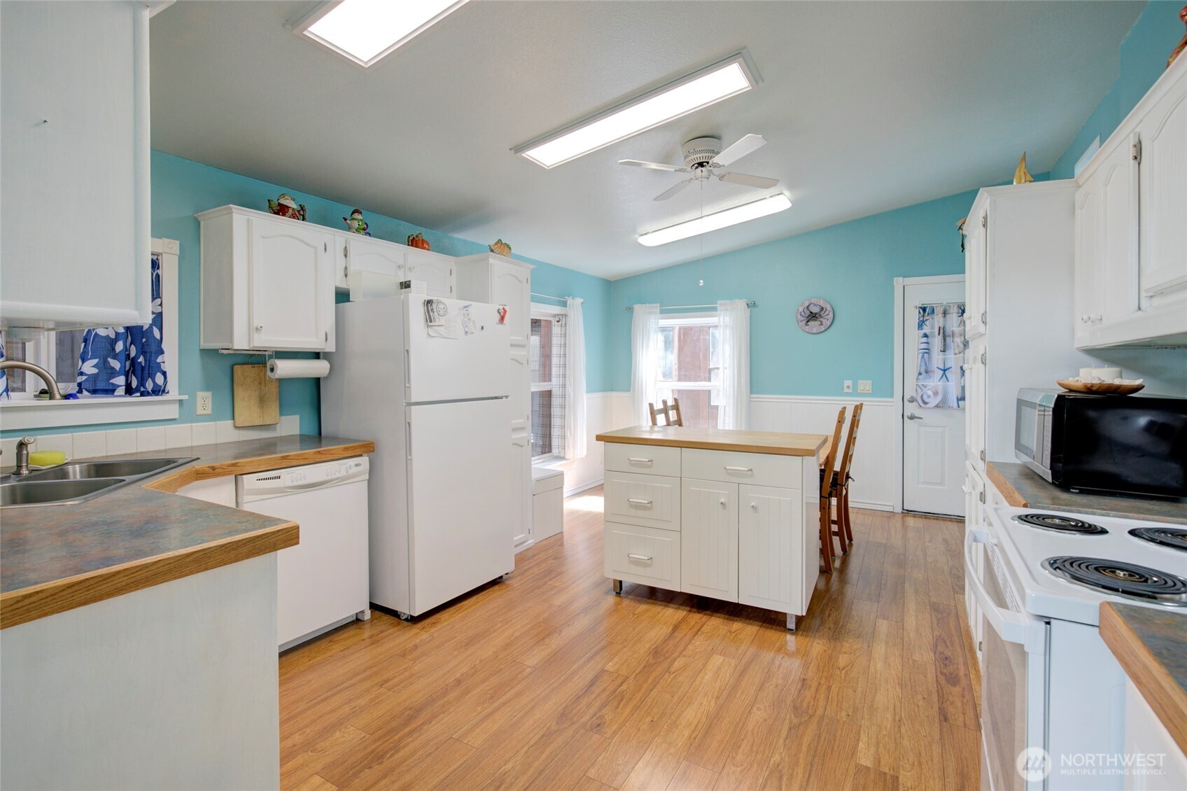 1362 Oceano Drive Grayland, WA 98547 - Photo 6 of 35 a kitchen with a refrigerator a stove top oven a counter space and wooden floor
