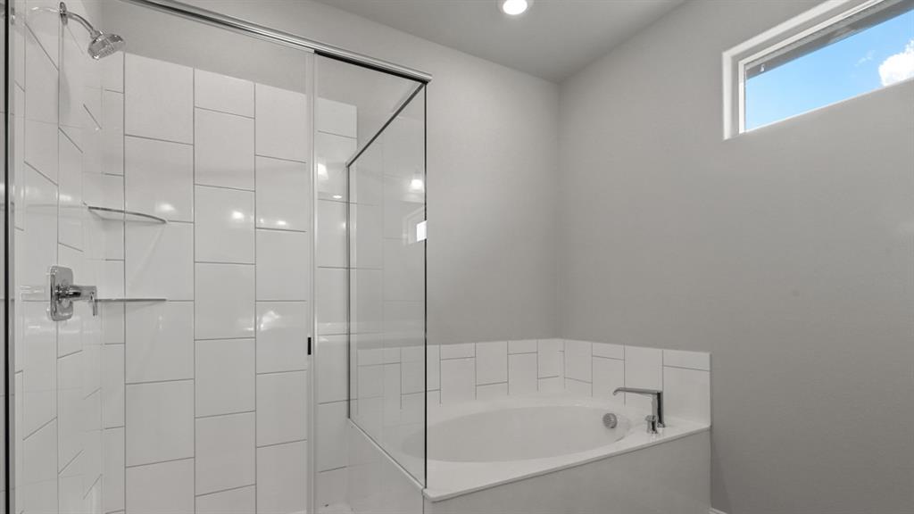 11209 Treehouse Trail Justin, TX 76247 - Photo 19 of 40 a bathroom with a bathtub and a shower