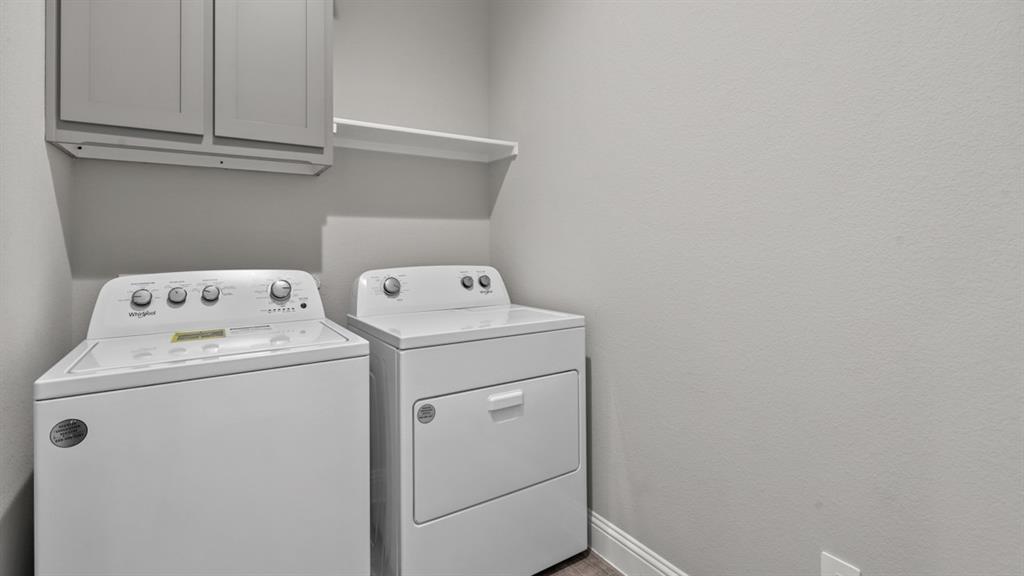 11209 Treehouse Trail Justin, TX 76247 - Photo 27 of 40 a utility room with dryer and washer