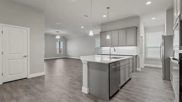 a front view of a house with a garden and plants