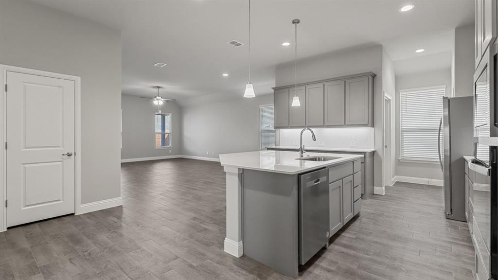 a kitchen with a sink stove and refrigerator