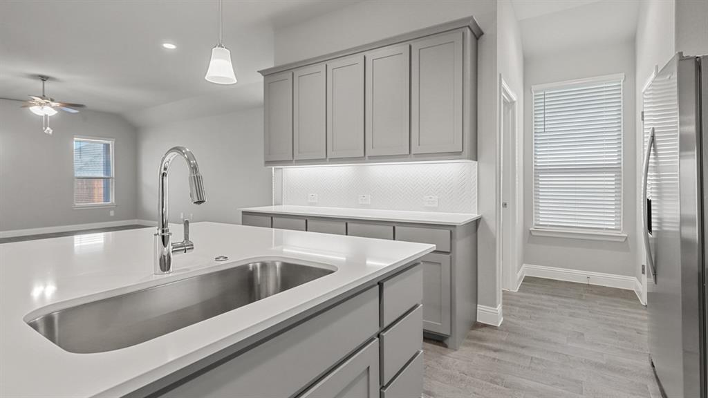 11209 Treehouse Trail Justin, TX 76247 - Photo 2 of 40 a kitchen with a sink and cabinets