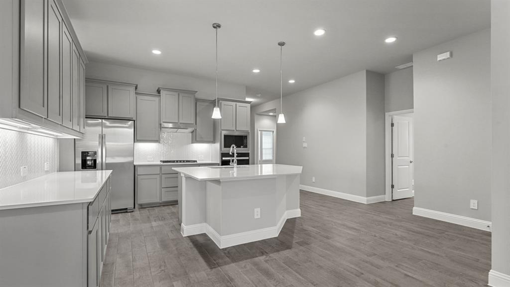 11209 Treehouse Trail Justin, TX 76247 - Photo 5 of 40 a large kitchen with cabinets