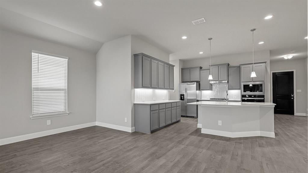 11209 Treehouse Trail Justin, TX 76247 - Photo 7 of 40 a kitchen with sink and wooden floor