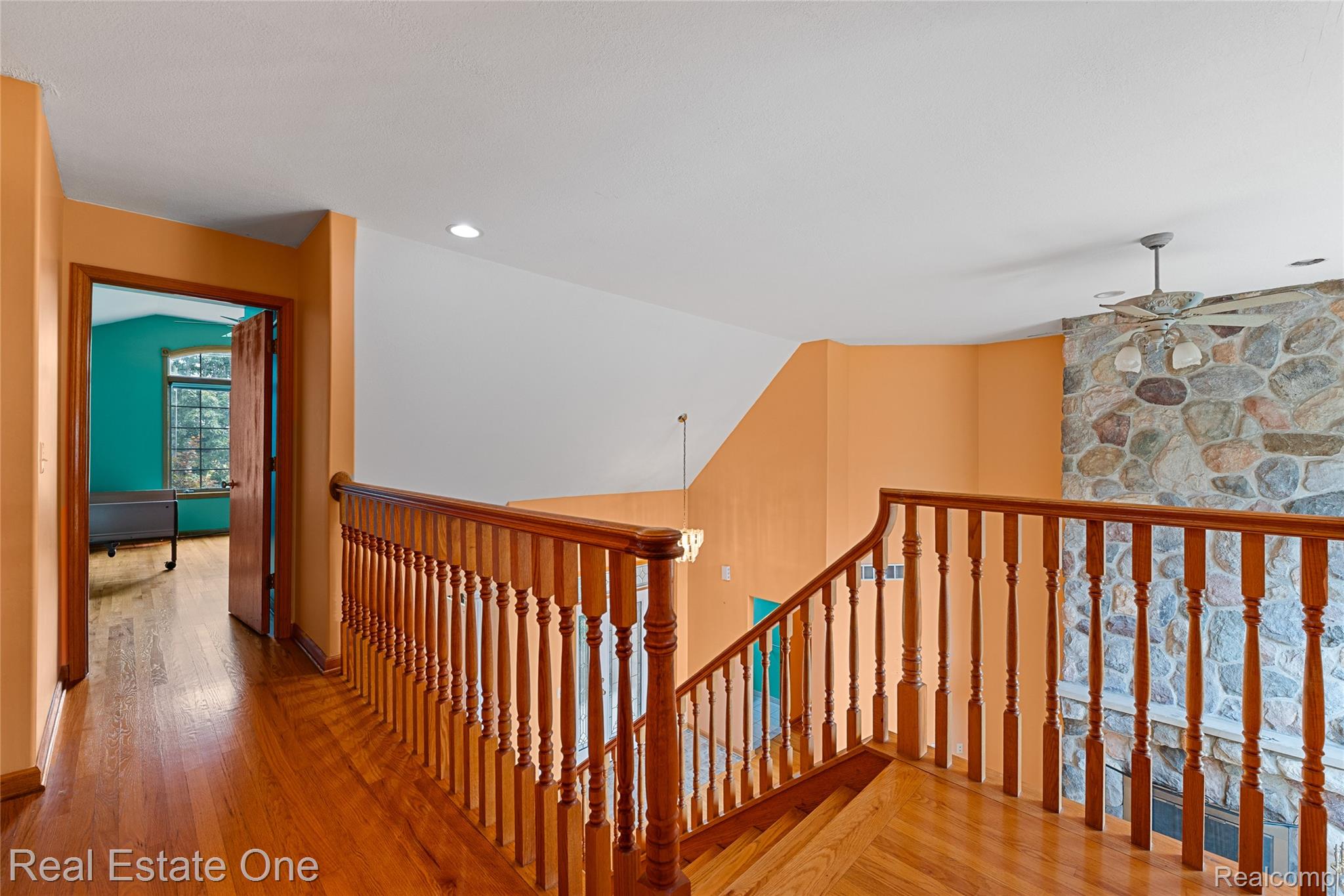 17268 Beech Daly Road Romulus, MI 48174 - Photo 47 of 60 Hardwood flooring, wood banister and railings, recessed lighting, and a stone accent wall