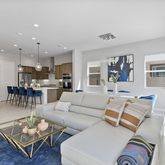 a living room with furniture and kitchen view