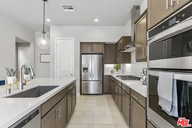 a kitchen with a sink stove and refrigerator