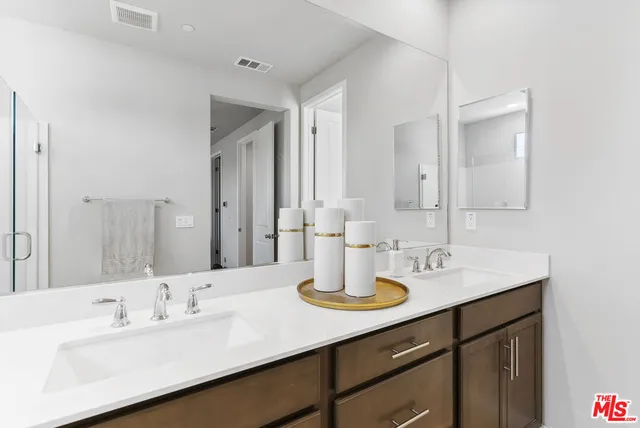 a bathroom with a sink vanity granite and a mirror