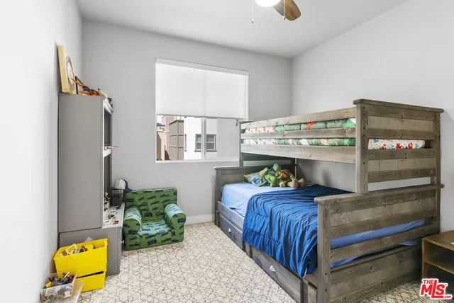 a bedroom with a bed and a dresser next to it