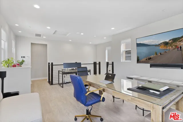 a bathroom with a granite countertop sink a toilet and a mirror
