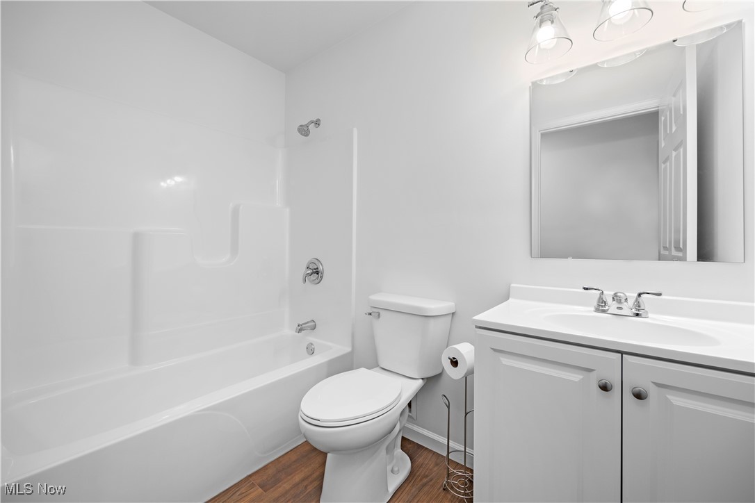 1996 East Oldgate Road Sandusky, OH 44870 - Photo 31 of 38 Full bathroom with shower / tub combination, vanity, hardwood / wood-style floors, and toilet. Master Builder Interior Photo
