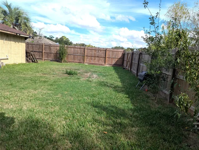 a view of a backyard with a garden and entertaining space