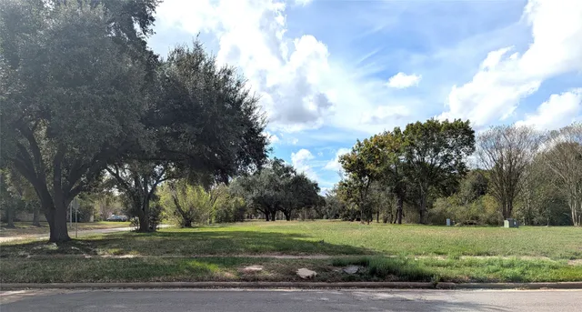 a view of a field with trees around