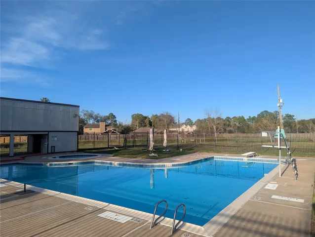 a view of house with pool and a yard