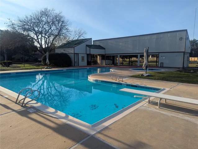 a view of a yard with table and chairs under an umbrella