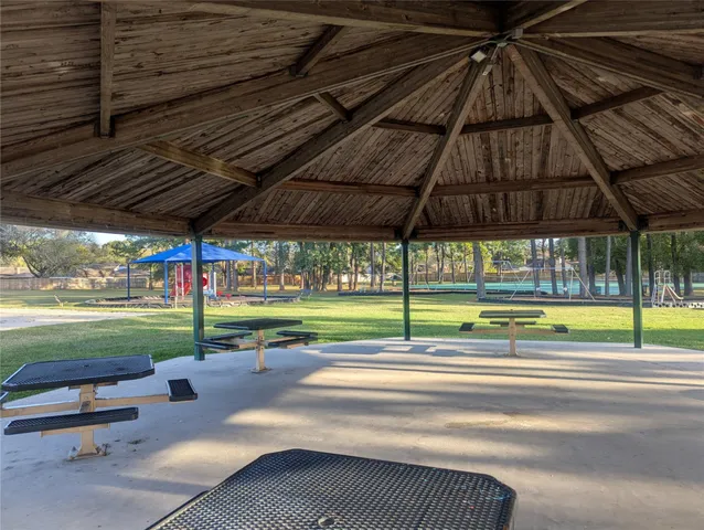 a view of swimming pool with sitting area and garden