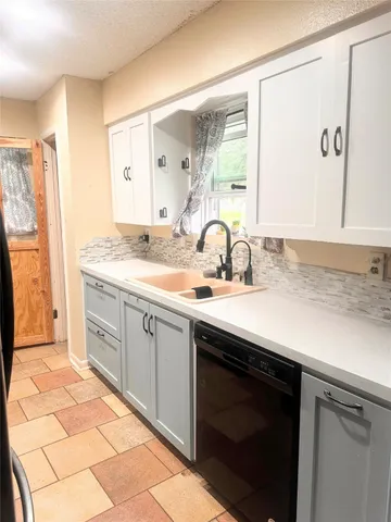 a spacious bathroom with a sink and a mirror