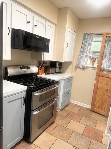 a kitchen with a stove and a microwave
