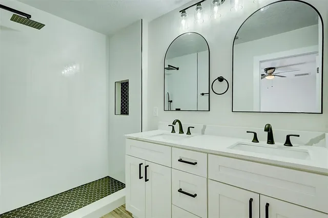 a bathroom with a double vanity sink and a mirror