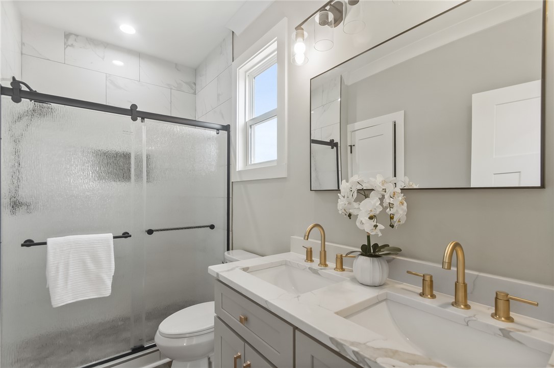 98 Turkey Trot Road Williamston, SC 29697 - Photo 15 of 18 This modern bathroom features a sleek vanity with double sinks, a spacious shower, and elegant fixtures.