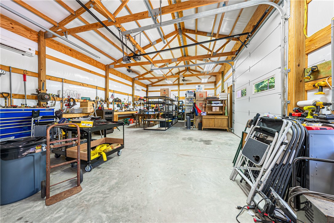 285 Bertha Allen Road Westminster, SC 29693 - Photo 48 of 50 Ample workspace awaits in this bright garage, complete with extensive workbenches and overhead lighting.
