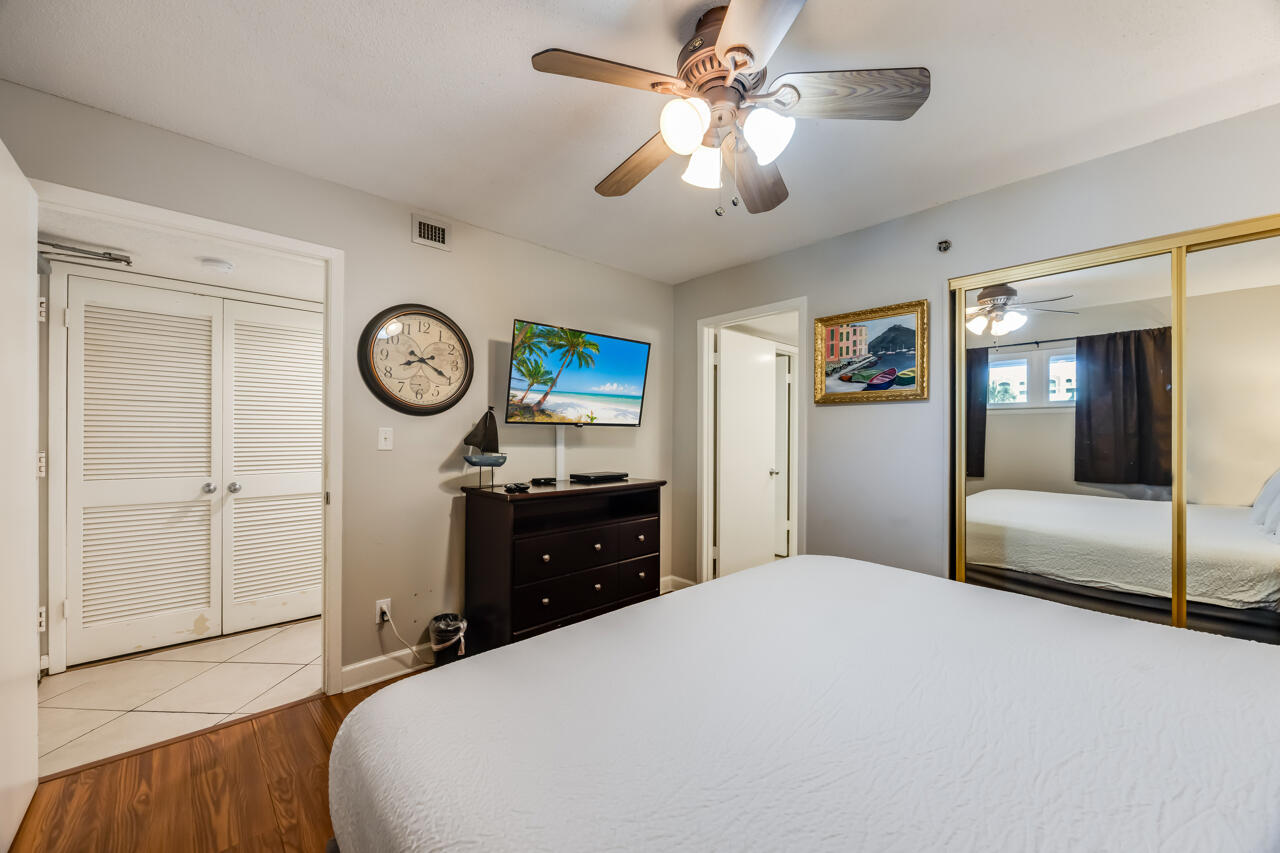 1114 Santa Rosa Boulevard, Unit 208 Fort Walton Beach, FL 32548 - Photo 17 of 73 a bedroom with a bed and a chandelier