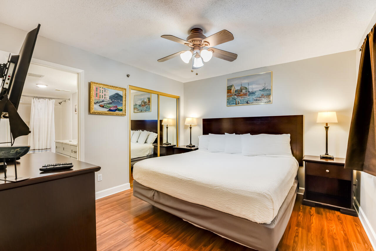 1114 Santa Rosa Boulevard, Unit 208 Fort Walton Beach, FL 32548 - Photo 18 of 73 a bedroom with a bed and a chandelier