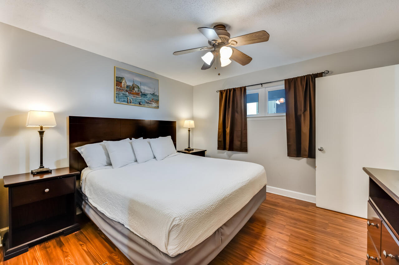 1114 Santa Rosa Boulevard, Unit 208 Fort Walton Beach, FL 32548 - Photo 19 of 73 a bed room with a bed and a chandelier