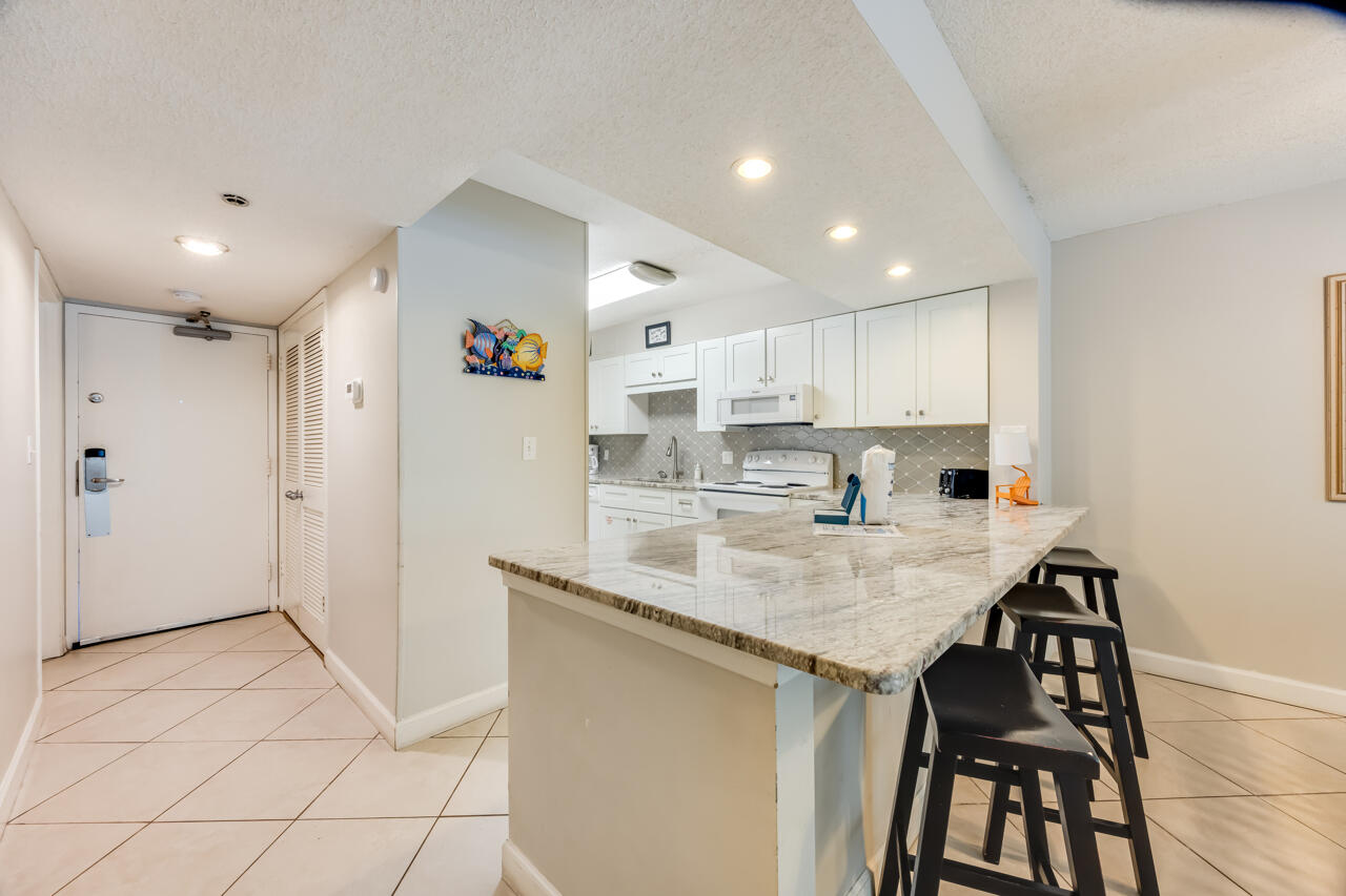 1114 Santa Rosa Boulevard, Unit 208 Fort Walton Beach, FL 32548 - Photo 2 of 73 a kitchen with stainless steel appliances granite countertop a refrigerator and a stove top oven