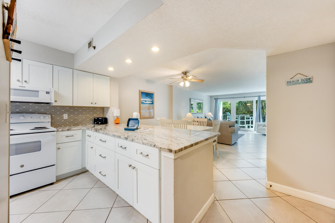 1114 Santa Rosa Boulevard, Unit 208 Fort Walton Beach, FL 32548 - Photo 3 of 73 a kitchen with stainless steel appliances granite countertop a sink and cabinets