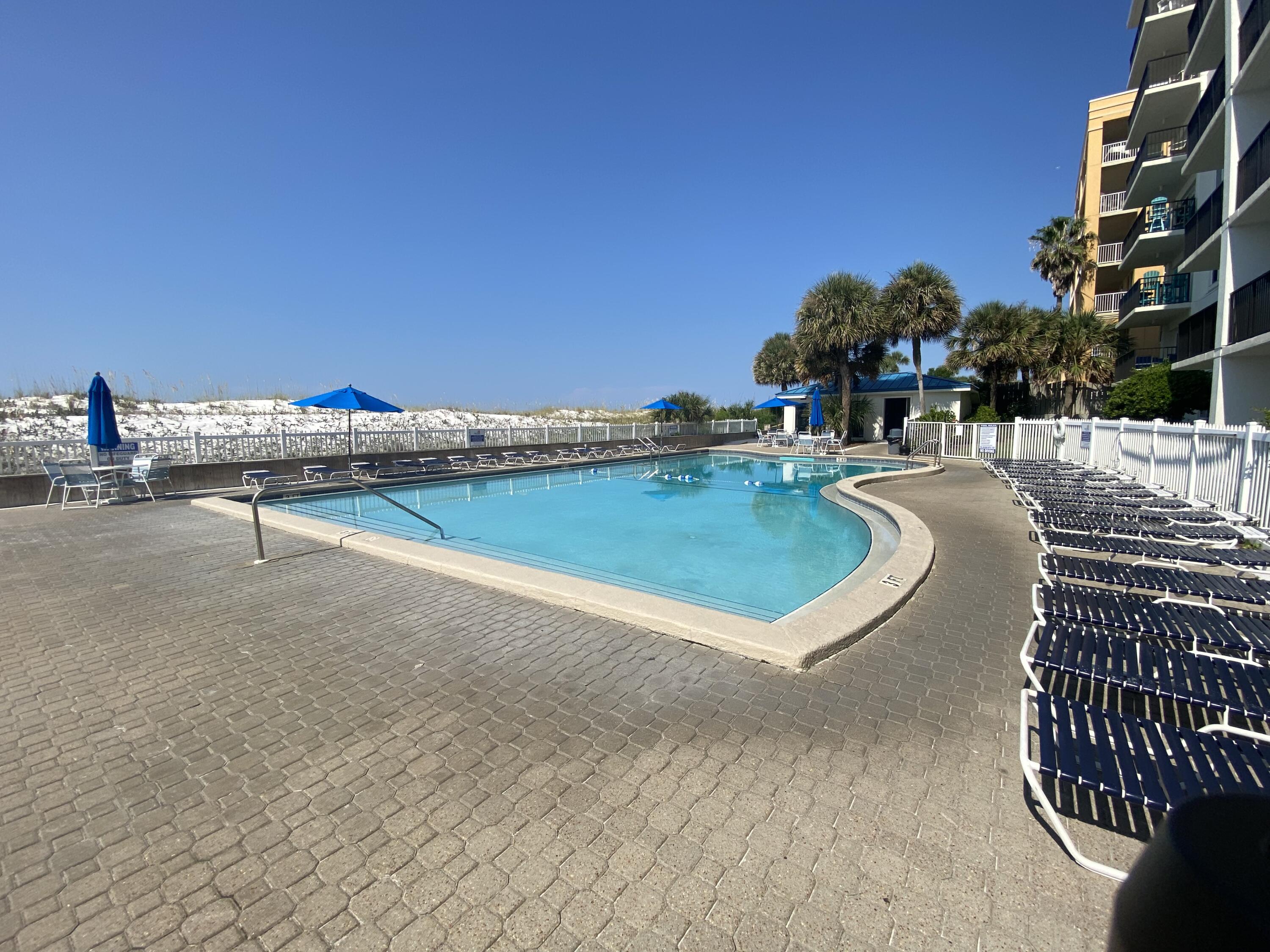 1114 Santa Rosa Boulevard, Unit 208 Fort Walton Beach, FL 32548 - Photo 37 of 73 a view of a swimming pool with a lounge chair