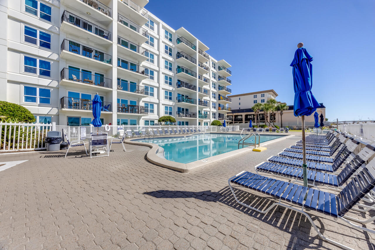 1114 Santa Rosa Boulevard, Unit 208 Fort Walton Beach, FL 32548 - Photo 41 of 73 a view of a swimming pool with a lounge chairs