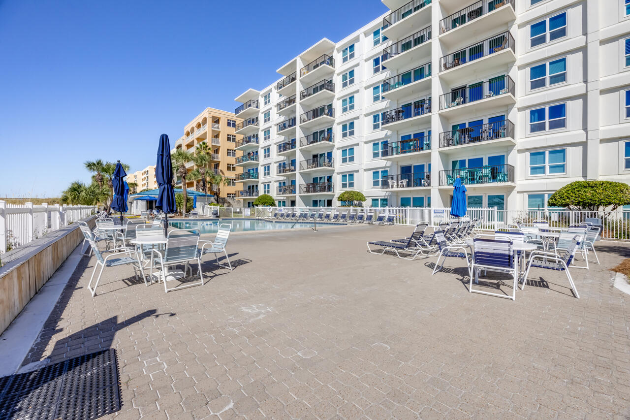 1114 Santa Rosa Boulevard, Unit 208 Fort Walton Beach, FL 32548 - Photo 46 of 73 a view of a patio with a table and chairs
