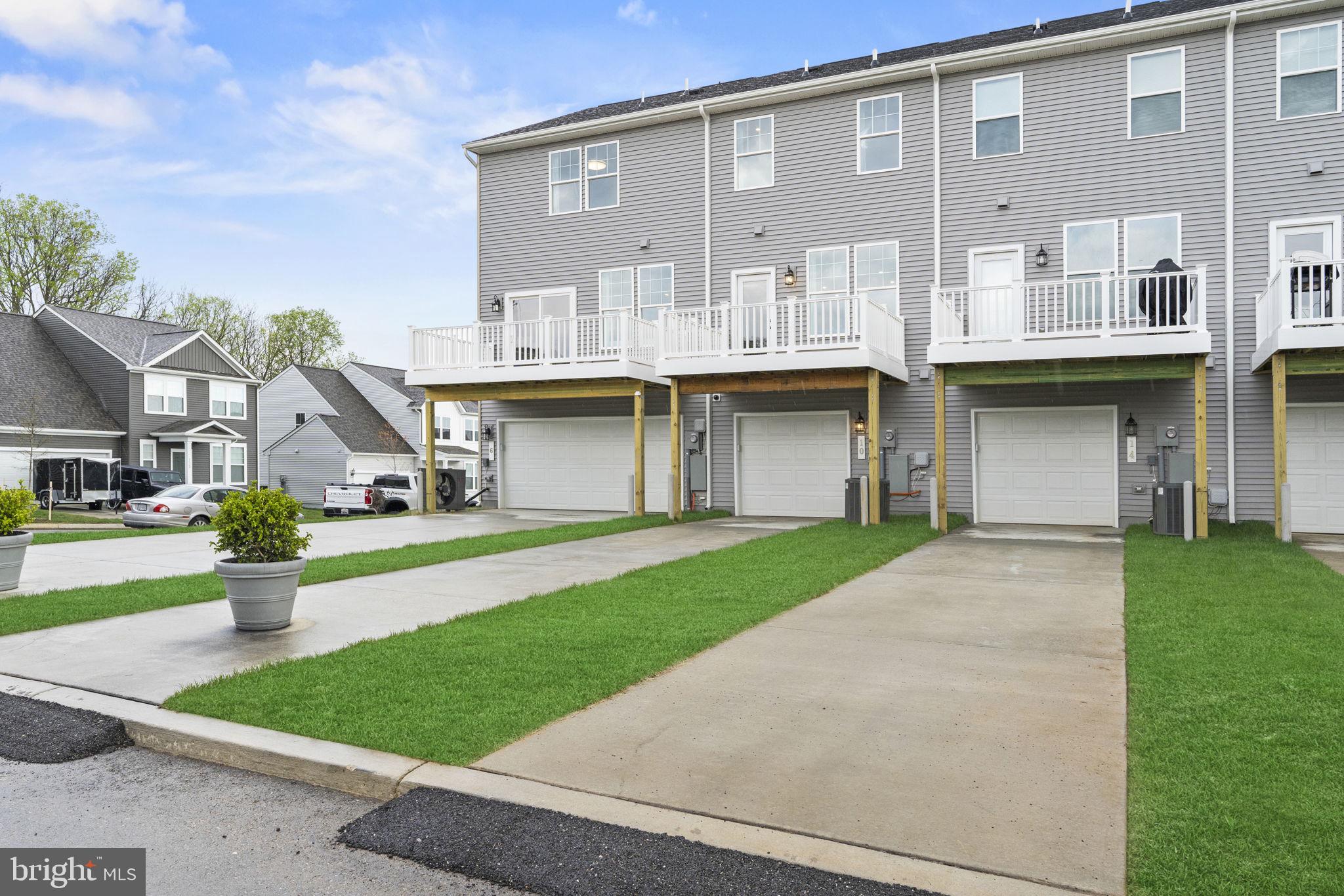 360 Anthem Street, Unit 445 Ranson, WV 25438 - Photo 55 of 87 a front view of a house with a garden and plants