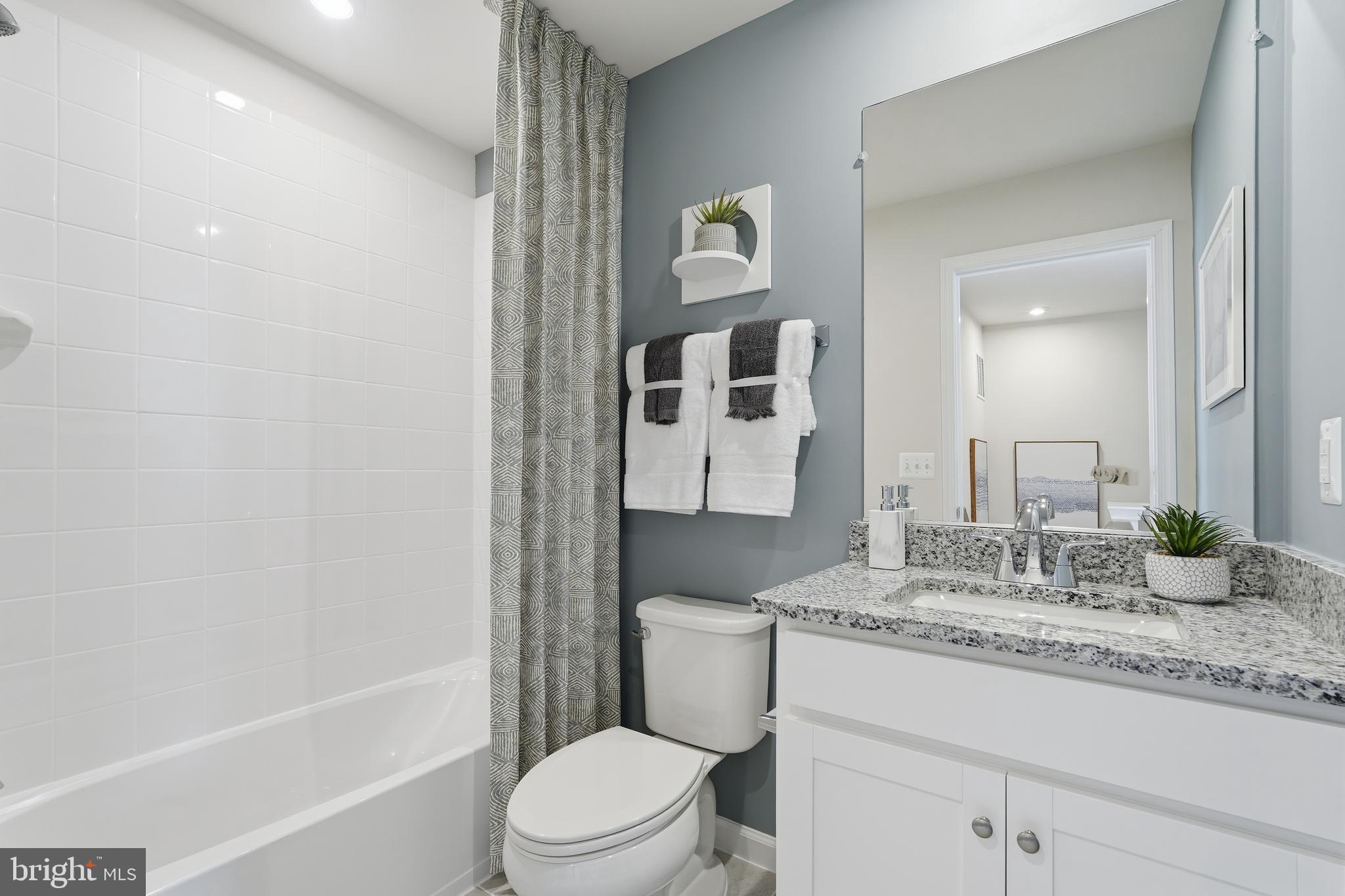 360 Anthem Street, Unit 445 Ranson, WV 25438 - Photo 74 of 87 a bathroom with a granite countertop sink toilet and shower