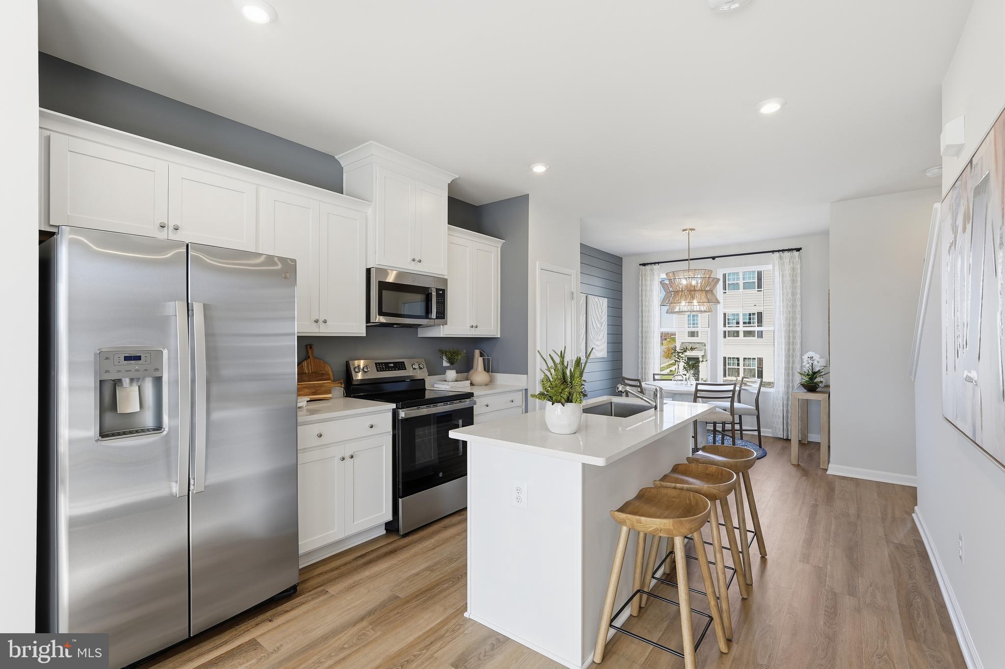 360 Anthem Street, Unit 445 Ranson, WV 25438 - Photo 83 of 87 a kitchen with stainless steel appliances granite countertop a refrigerator a stove top oven a sink dishwasher and white cabinets with wooden floor