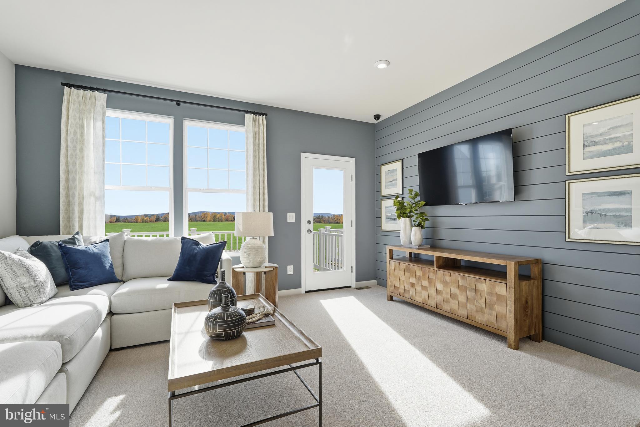 360 Anthem Street, Unit 445 Ranson, WV 25438 - Photo 85 of 87 a living room with furniture and a fireplace