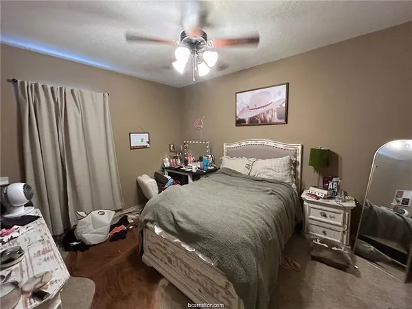 a bedroom with bed and a window