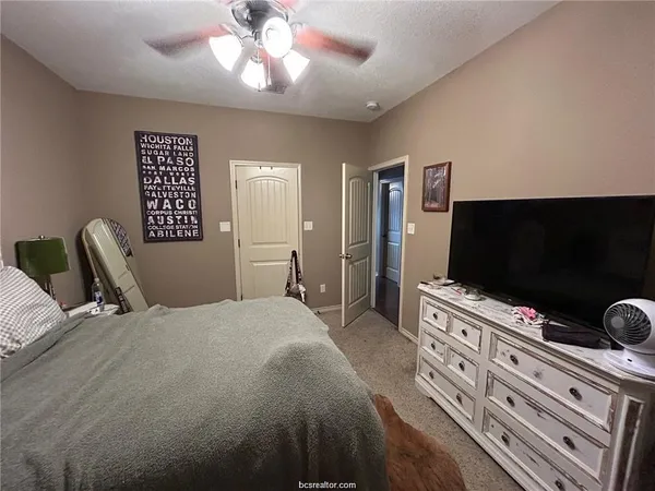 a bedroom with a bed and a flat screen tv
